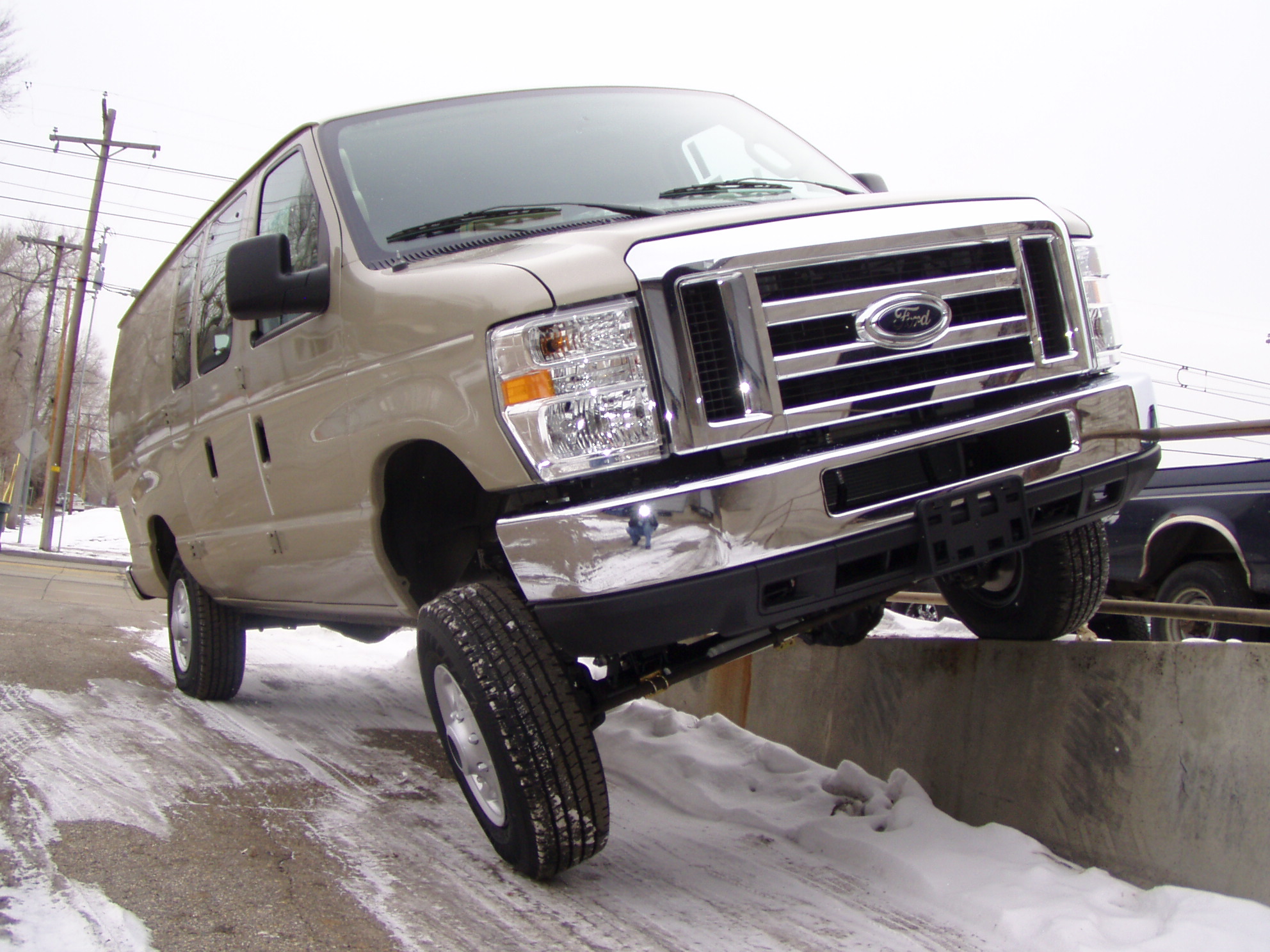 ford 4x4 van driving on curb